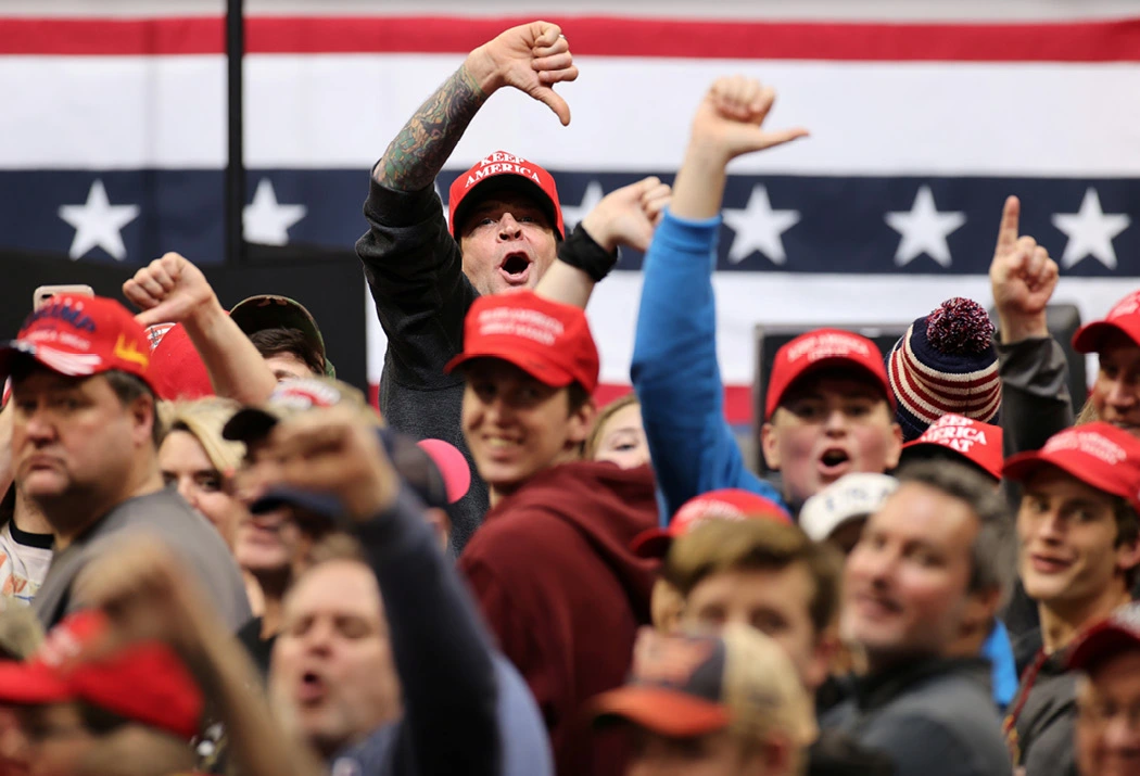 Trump supporters boo the media at a rally in Iowa. (Reuters)